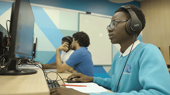 Talk-Think-Do-Partner-Imagery Image of child wearing headphones sitting at a computer